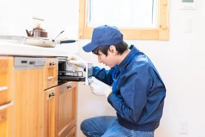 Trabajador realizando reparaciones menores en una pared de gypsum.